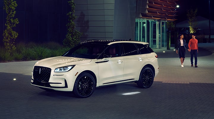 Two people approach a 2024 Lincoln Corsair® SUV featuring the available Jet Appearance Package. | Allan Vigil Lincoln, Inc. in Morrow GA