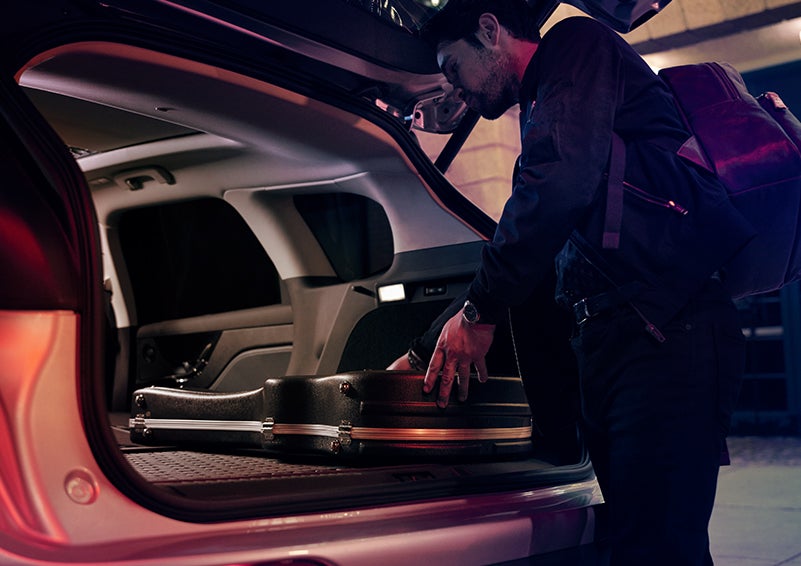 A man is shown loading cargo into the rear of a 2024 Lincoln Corsair® SUV with the second-row seats folded flat. | Allan Vigil Lincoln, Inc. in Morrow GA