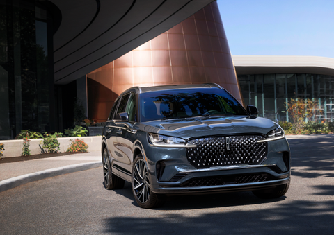 A gray 2025 Lincoln Aviator® SUV is parked outside a modern building with the sun shining. | Allan Vigil Lincoln, Inc. in Morrow GA