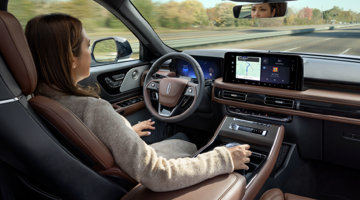 A woman is seen sitting in the driver’s seat of her 2025 Lincoln Aviator® SUV with her hands off the steering wheel. | Allan Vigil Lincoln, Inc. in Morrow GA