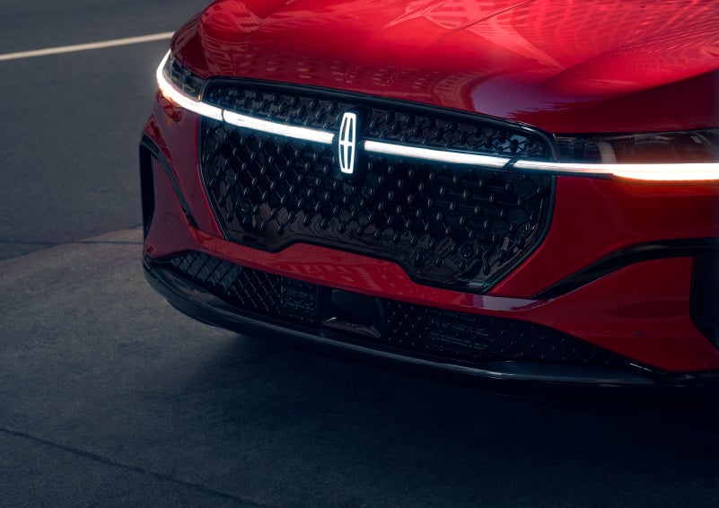 The available front LED light bar and center Lincoln Star logo glow at dusk. | Allan Vigil Lincoln, Inc. in Morrow GA