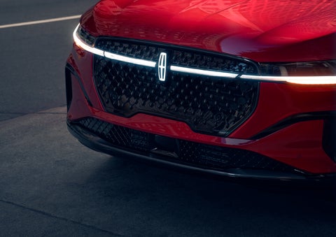 The available front LED light bar and center Lincoln Star logo glow at dusk. | Allan Vigil Lincoln, Inc. in Morrow GA