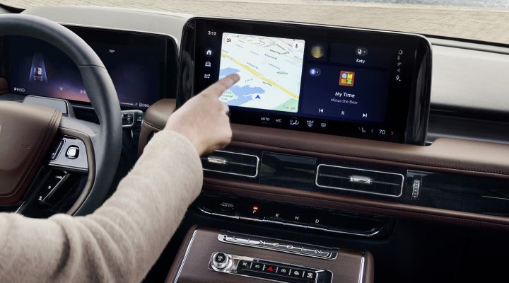 A person is tapping the center display touchscreen of a 2026 Lincoln Aviator® SUV. | Allan Vigil Lincoln, Inc. in Morrow GA
