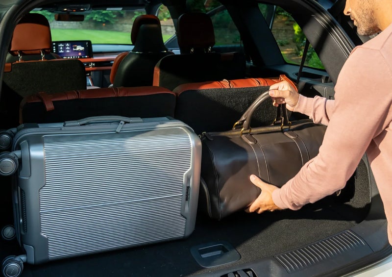 A man loads luggage into the rear of a 2026 Lincoln Aviator® SUV through the opened rear liftgate. | Allan Vigil Lincoln, Inc. in Morrow GA