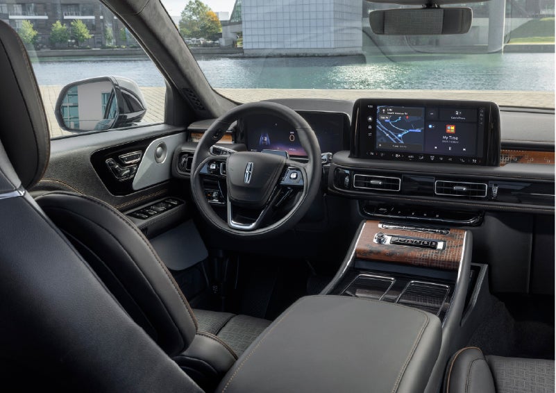 The interior of the 2026 Lincoln Aviator® SUV is shown parked with a view of a harbor through the windshield. | Allan Vigil Lincoln, Inc. in Morrow GA