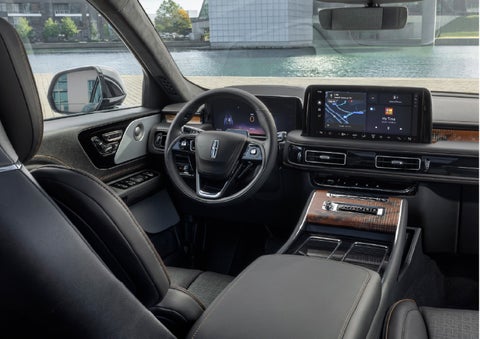 The interior of the 2026 Lincoln Aviator® SUV is shown parked with a view of a harbor through the windshield. | Allan Vigil Lincoln, Inc. in Morrow GA