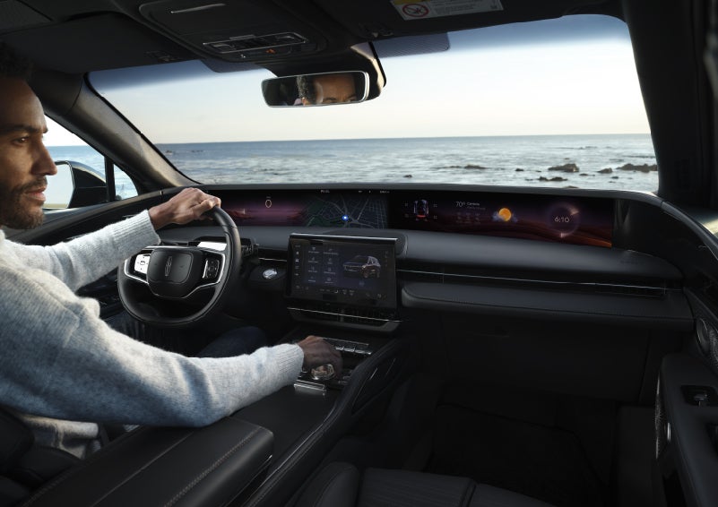 A driver of a parked 2026 Lincoln Nautilus® SUV takes a relaxing moment at a seaside overlook while inside his Nautilus. | Allan Vigil Lincoln, Inc. in Morrow GA