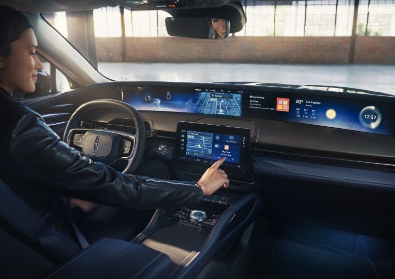 The driver of a 2026 Lincoln Nautilus® SUV interacts with the center touchscreen. | Allan Vigil Lincoln, Inc. in Morrow GA