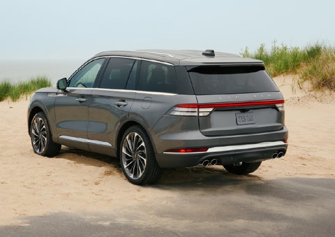 A 2027 Lincoln Aviator® SUV is parked next to sand dunes. | Allan Vigil Lincoln, Inc. in Morrow GA