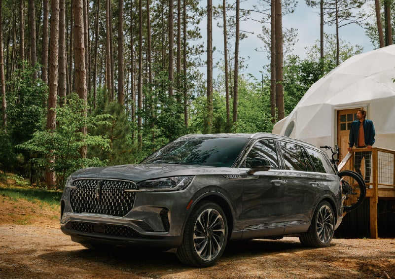 A 2027 Lincoln Aviator® is parked next to a high end glamping site. | Allan Vigil Lincoln, Inc. in Morrow GA