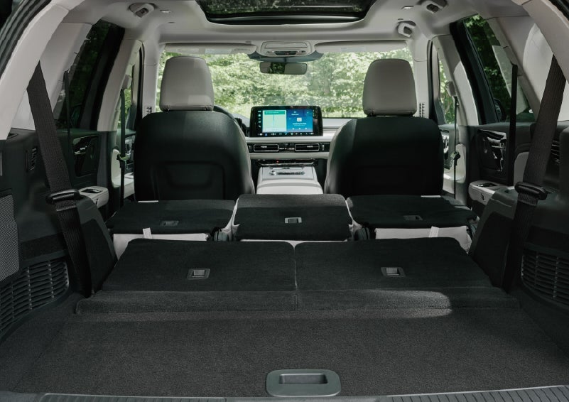 A rear to front view of the interior of a 2027 Lincoln Aviator® Black Label™ SUV shows the third and second rows folded flat | Allan Vigil Lincoln, Inc. in Morrow GA