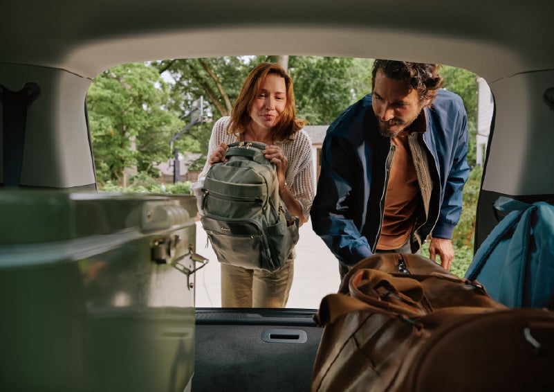 A couple loads luggage into the rear of a 2027 Lincoln Aviator® Black Label™ SUV..e 202 | Allan Vigil Lincoln, Inc. in Morrow GA