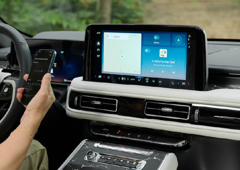 A person pairs thier phone with the center touchscreen of a 2027 Lincoln Aviator® Black Label™ SUV | Allan Vigil Lincoln, Inc. in Morrow GA